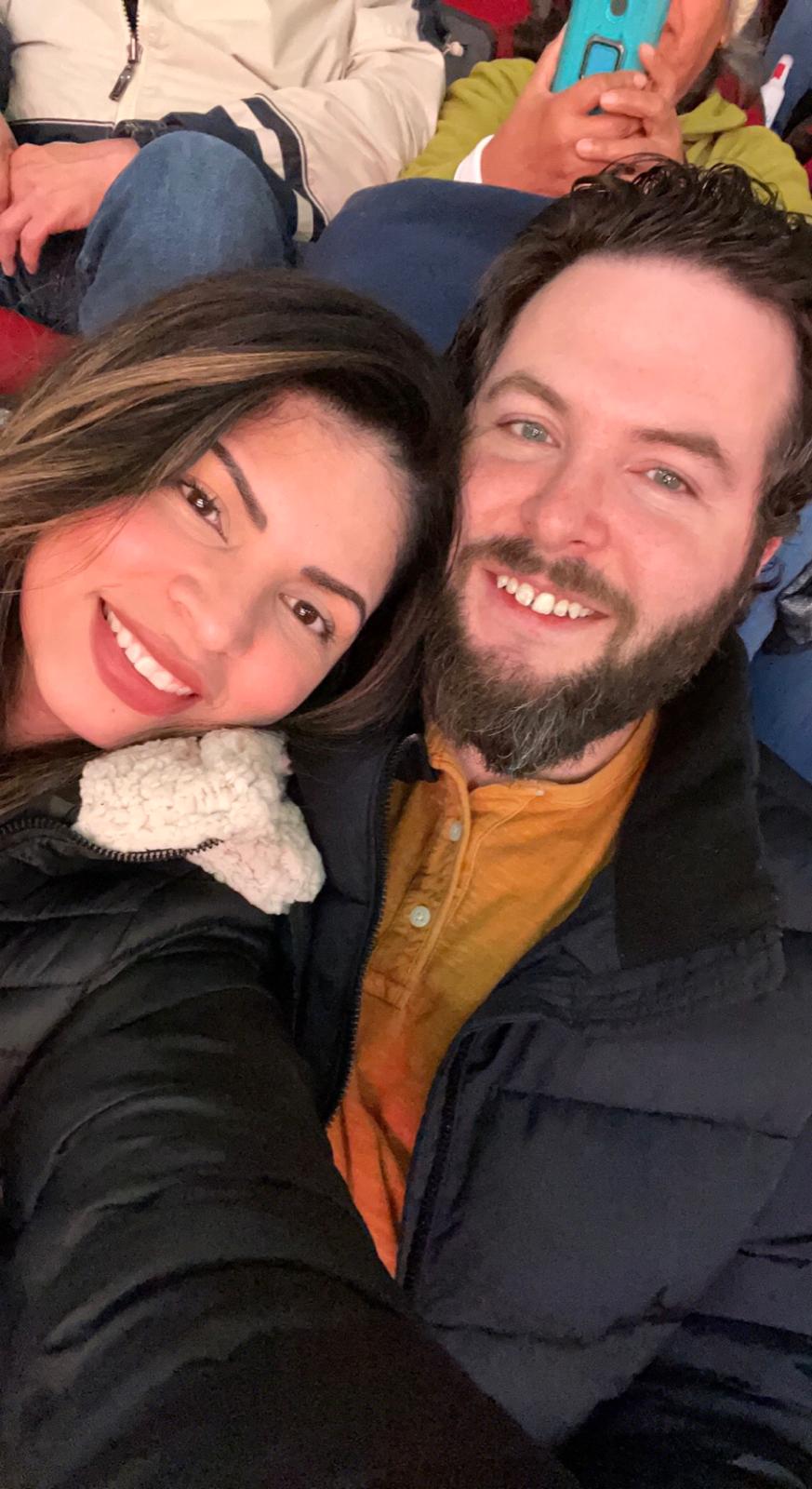 Karen and Travis smiling together in their winter jackets