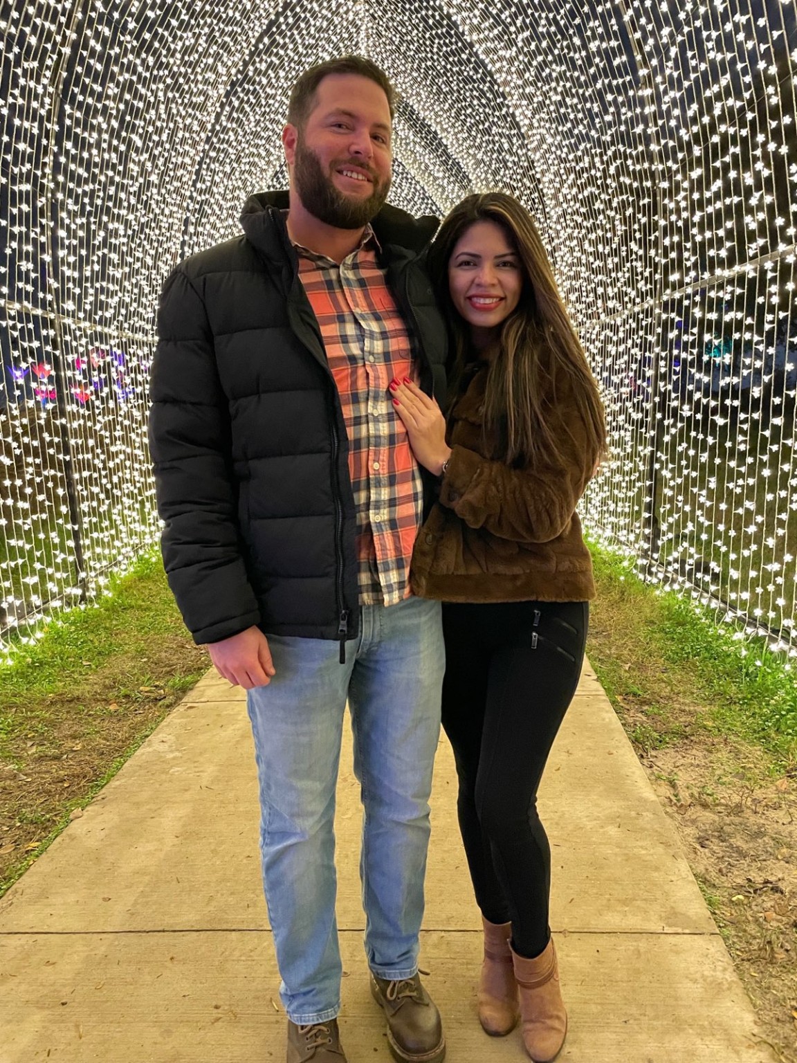Karen and Travis beneath glowing garden lights